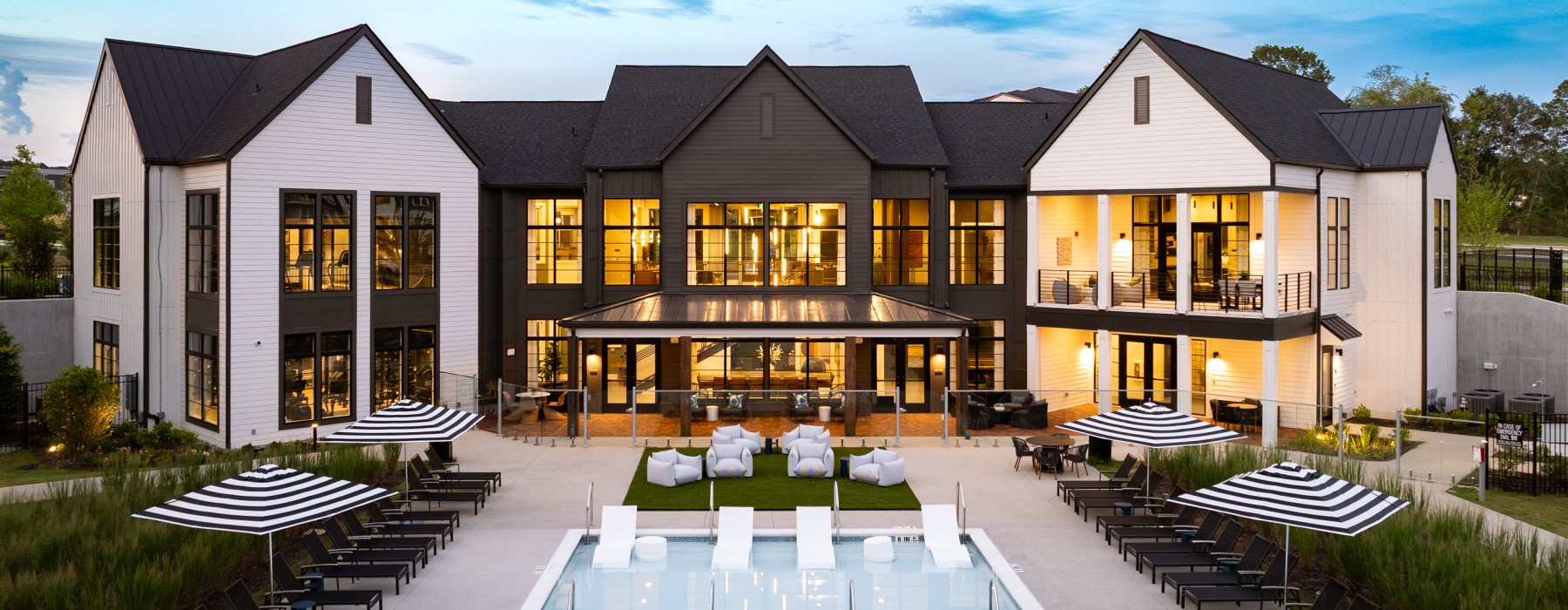 a building with lights and a pool